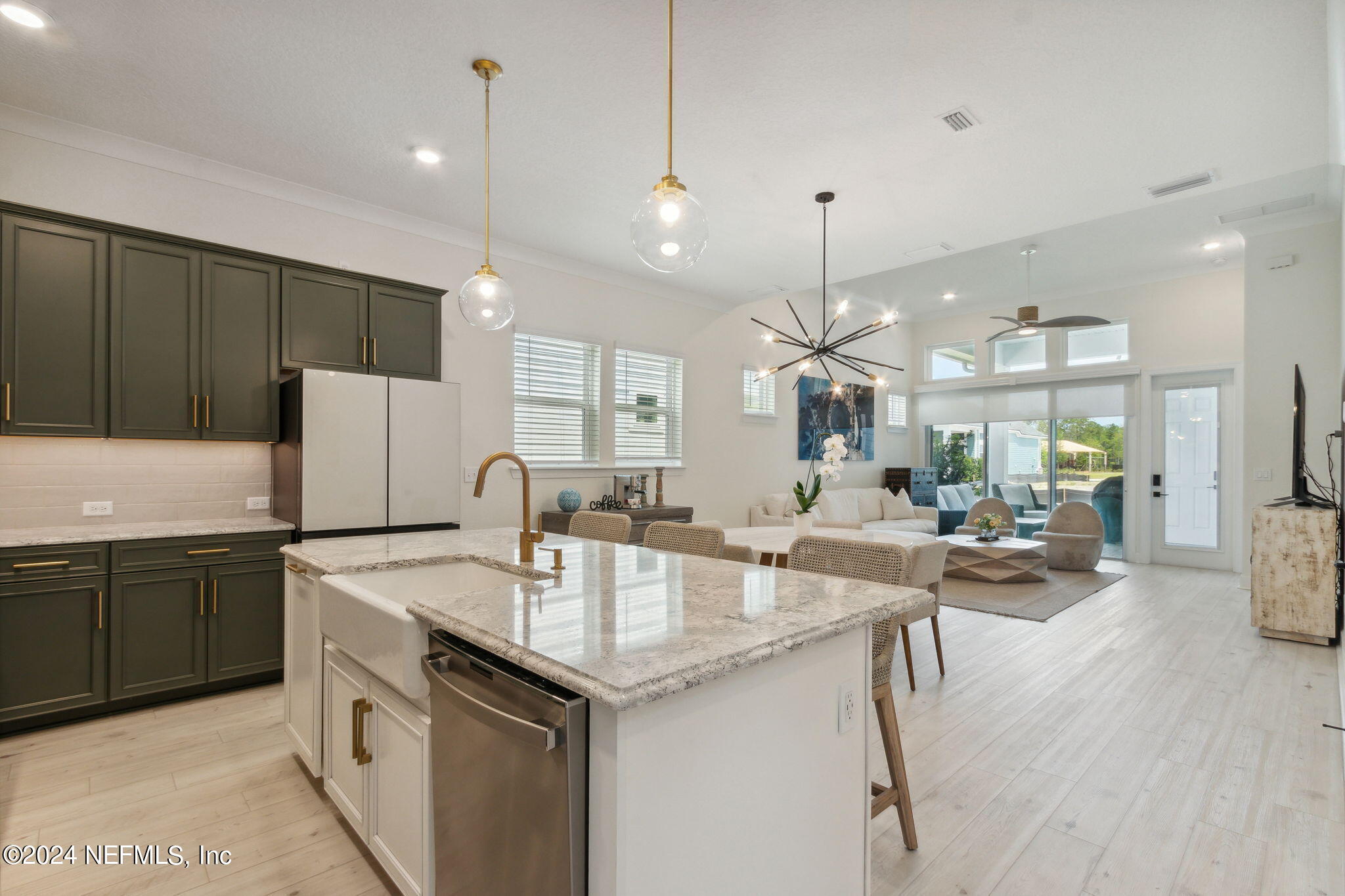 a kitchen with center island white cabinets and stainless steel appliances