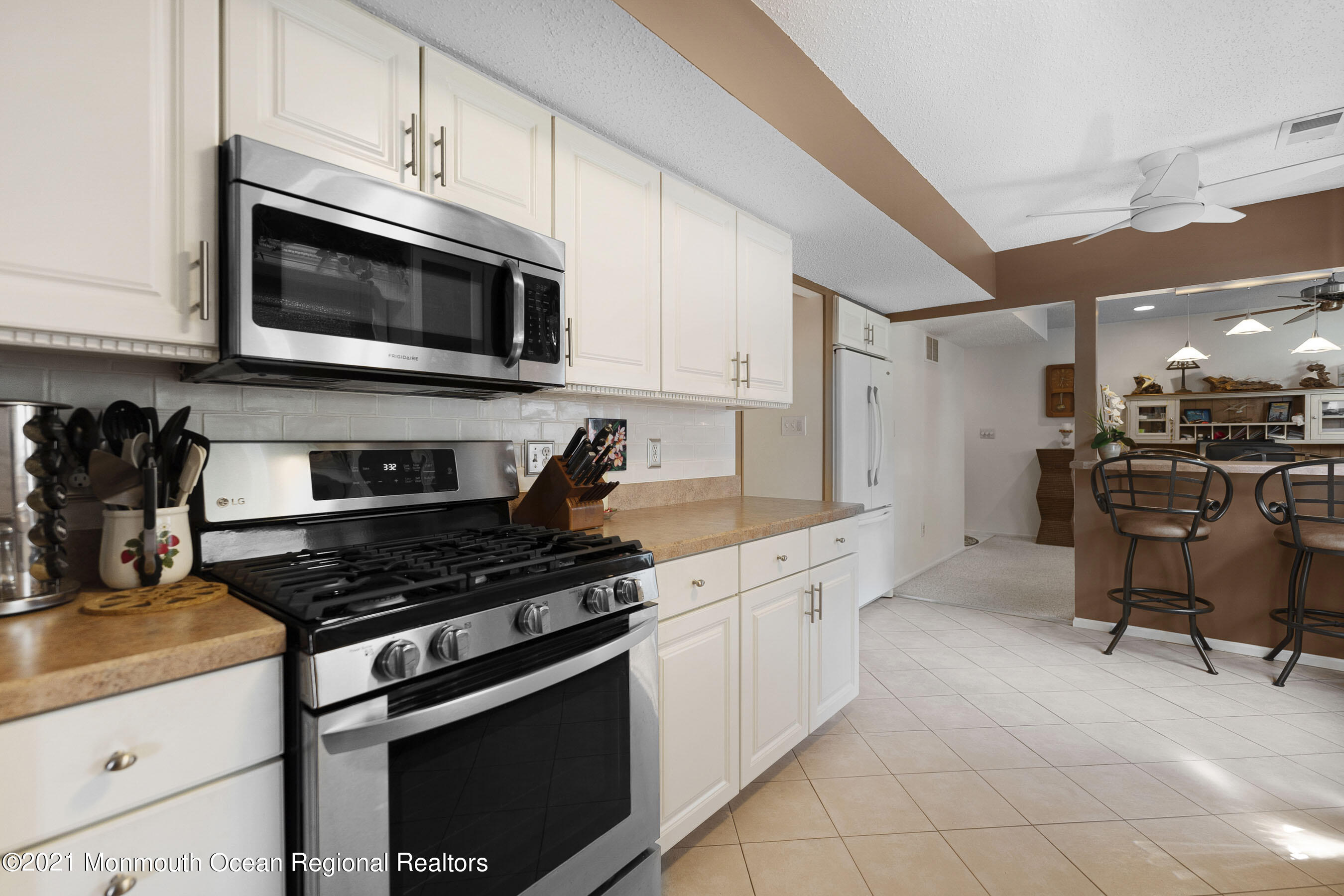 808 Constitution Drive Brick, NJ 08724 - Photo 12 of 27 a kitchen with stainless steel appliances a stove microwave and cabinets