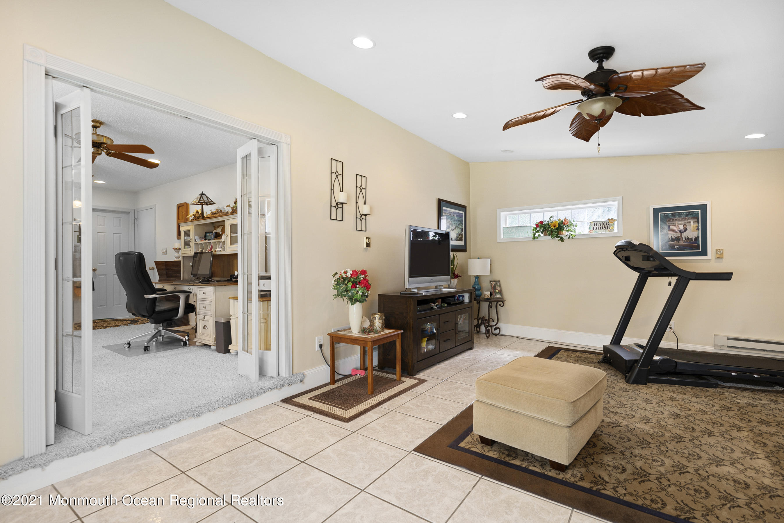 808 Constitution Drive Brick, NJ 08724 - Photo 17 of 27 a room with gym equipment and a view of living room