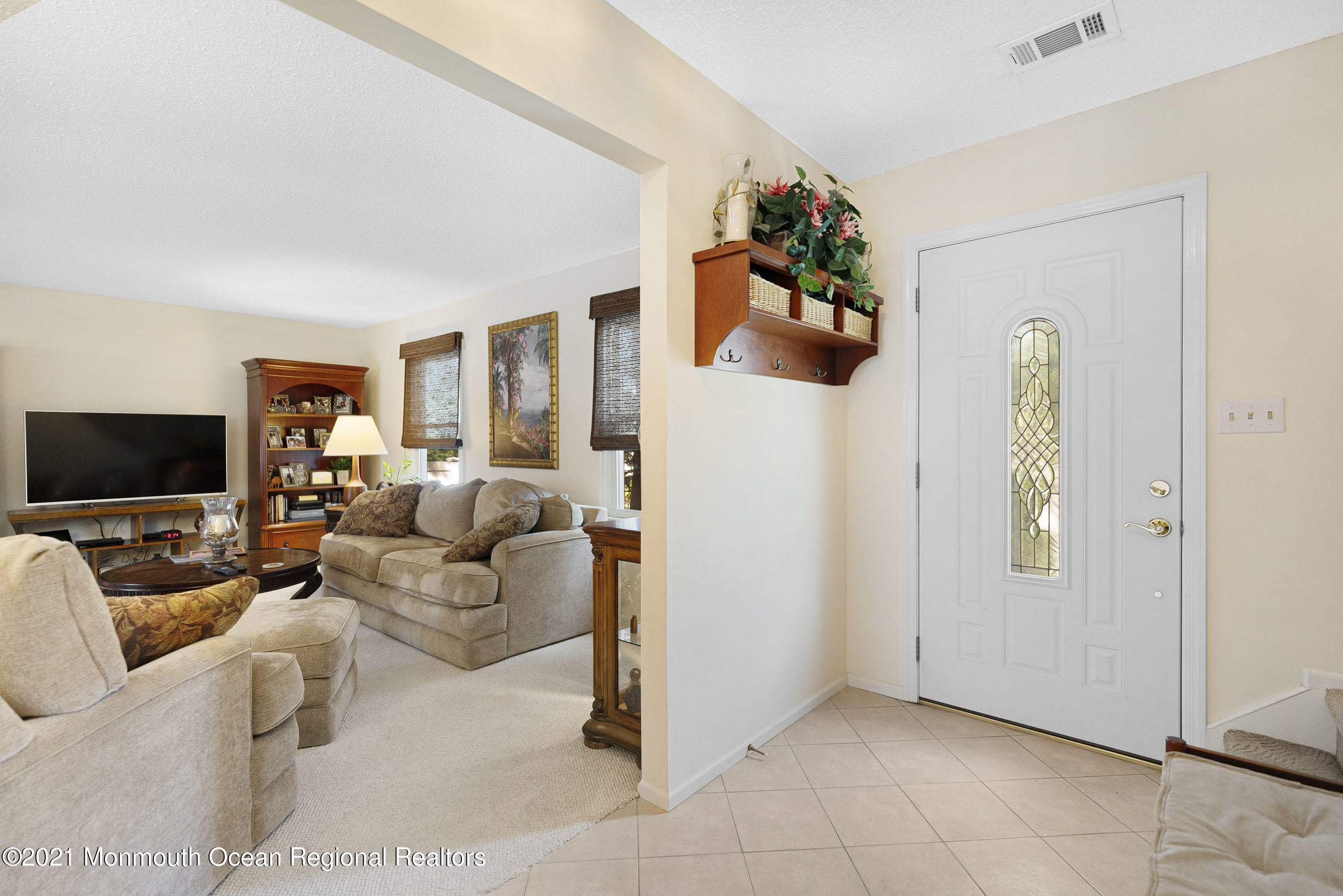 808 Constitution Drive Brick, NJ 08724 - Photo 3 of 27 a living room with furniture and a flat screen tv