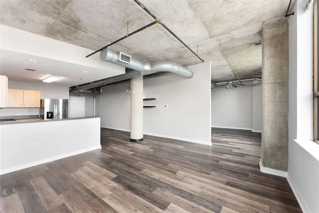 a view of a livingroom with wooden floor and a ceiling fan