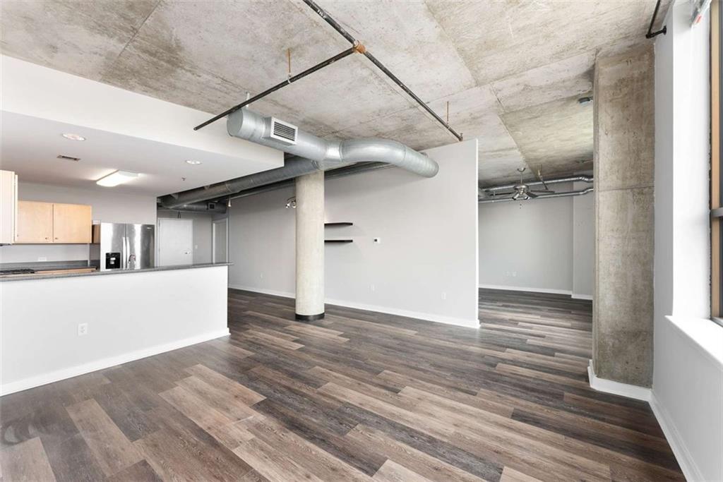 115 West Peachtree Street Northwest, Unit 704 Atlanta, GA 30313 - Photo 11 of 35 a view of an empty room with wooden floor and a window