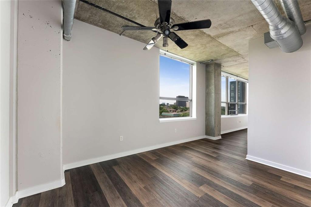 115 West Peachtree Street Northwest, Unit 704 Atlanta, GA 30313 - Photo 12 of 35 a view of a livingroom with wooden floor and a ceiling fan