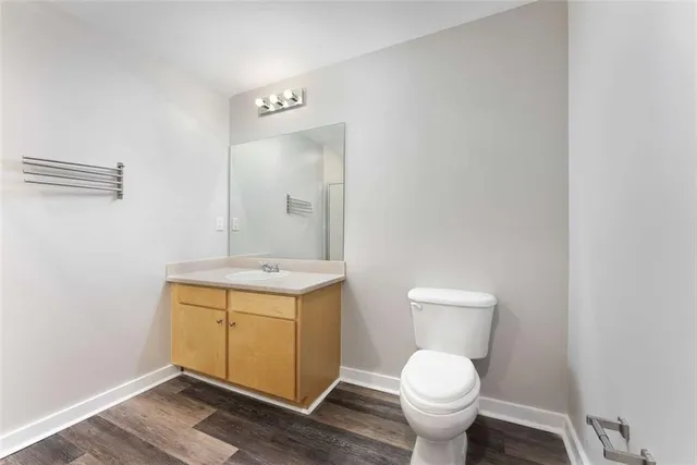 an empty room with wooden floor and closet