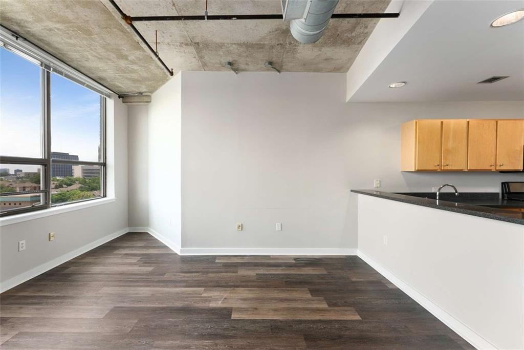 115 West Peachtree Street Northwest, Unit 704 Atlanta, GA 30313 - Photo 7 of 35 a view of a kitchen with wooden floor and a sink