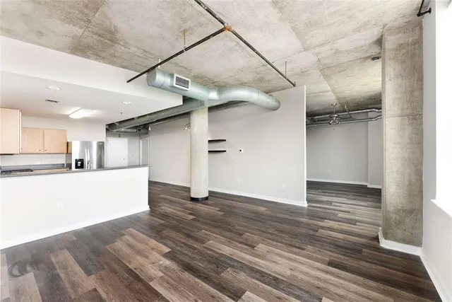 a view of a room with wooden floors and windows