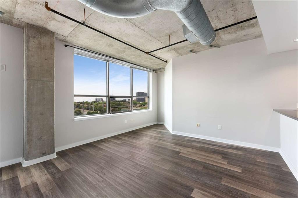 115 West Peachtree Street Northwest, Unit 704 Atlanta, GA 30313 - Photo 9 of 35 a view of a room with wooden floors and windows