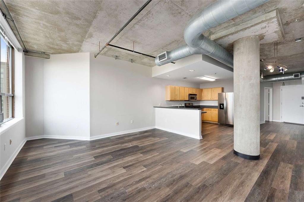 115 West Peachtree Street Northwest, Unit 704 Atlanta, GA 30313 - Photo 10 of 35 a view of a kitchen with refrigerator and wooden floor