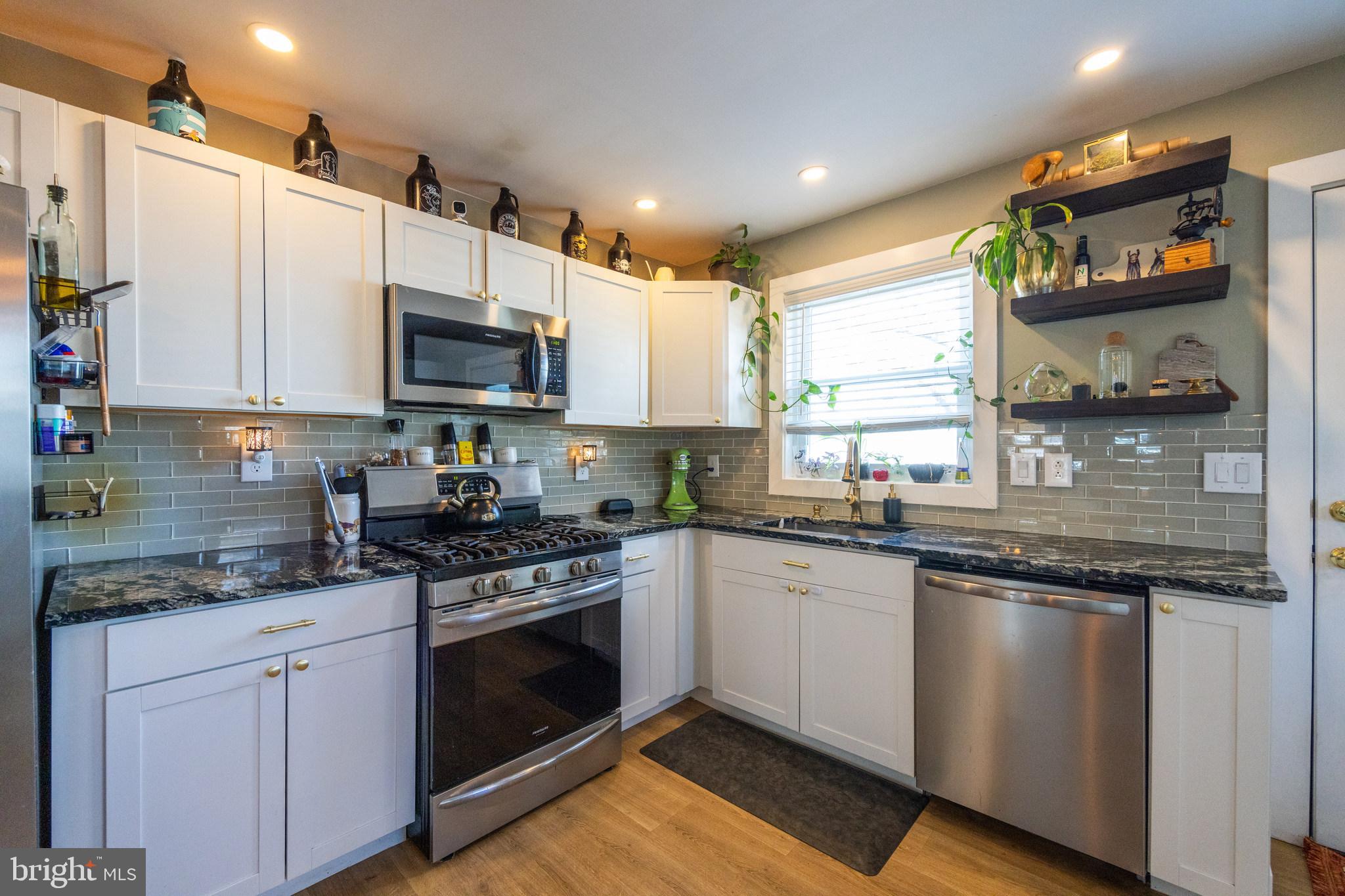 178 Devon Drive West Deptford, NJ 08096 - Photo 11 of 29 a kitchen with stainless steel appliances granite countertop a stove a sink and a microwave