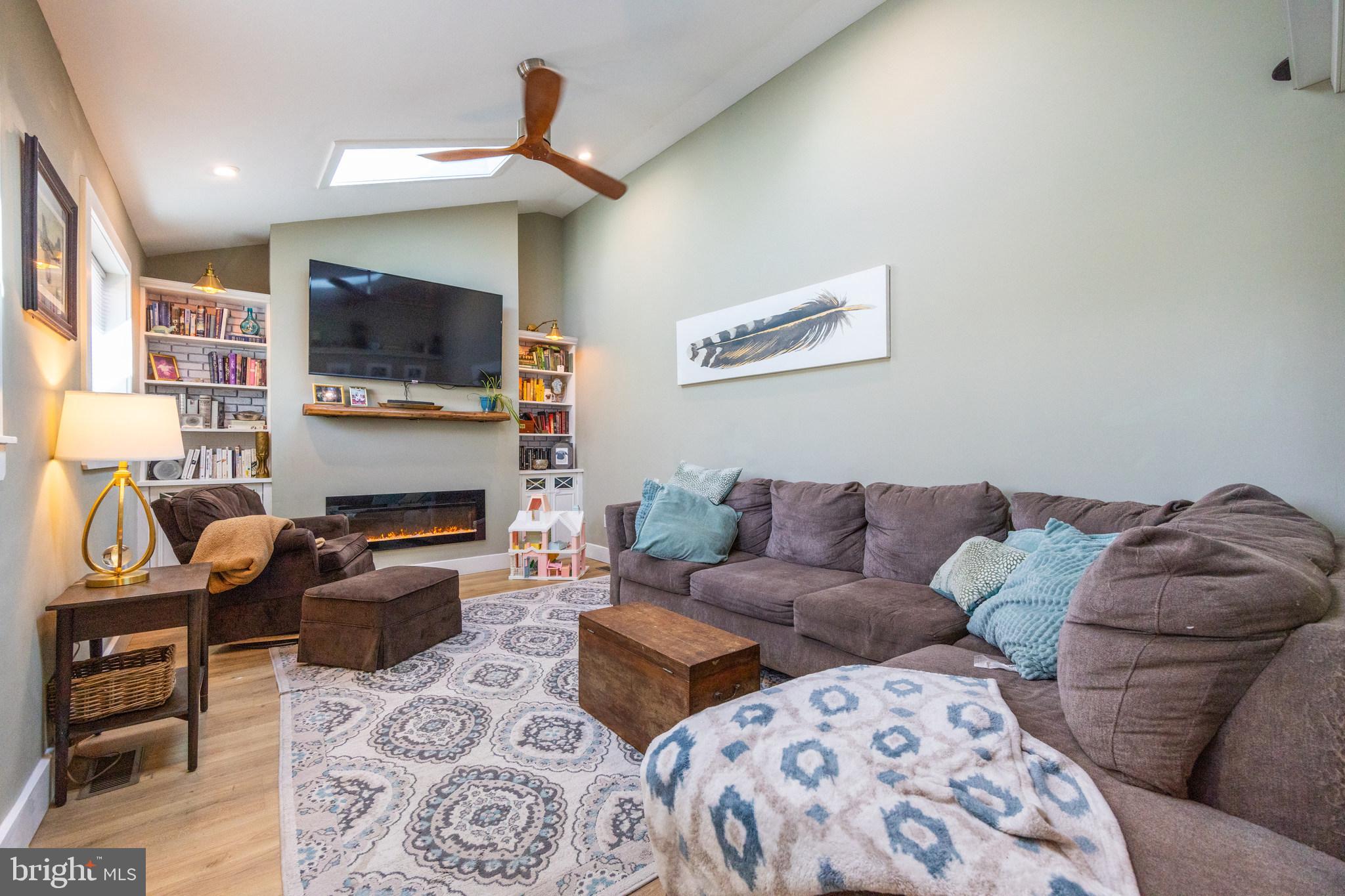 178 Devon Drive West Deptford, NJ 08096 - Photo 7 of 29 a living room with furniture a flat screen tv and a fireplace