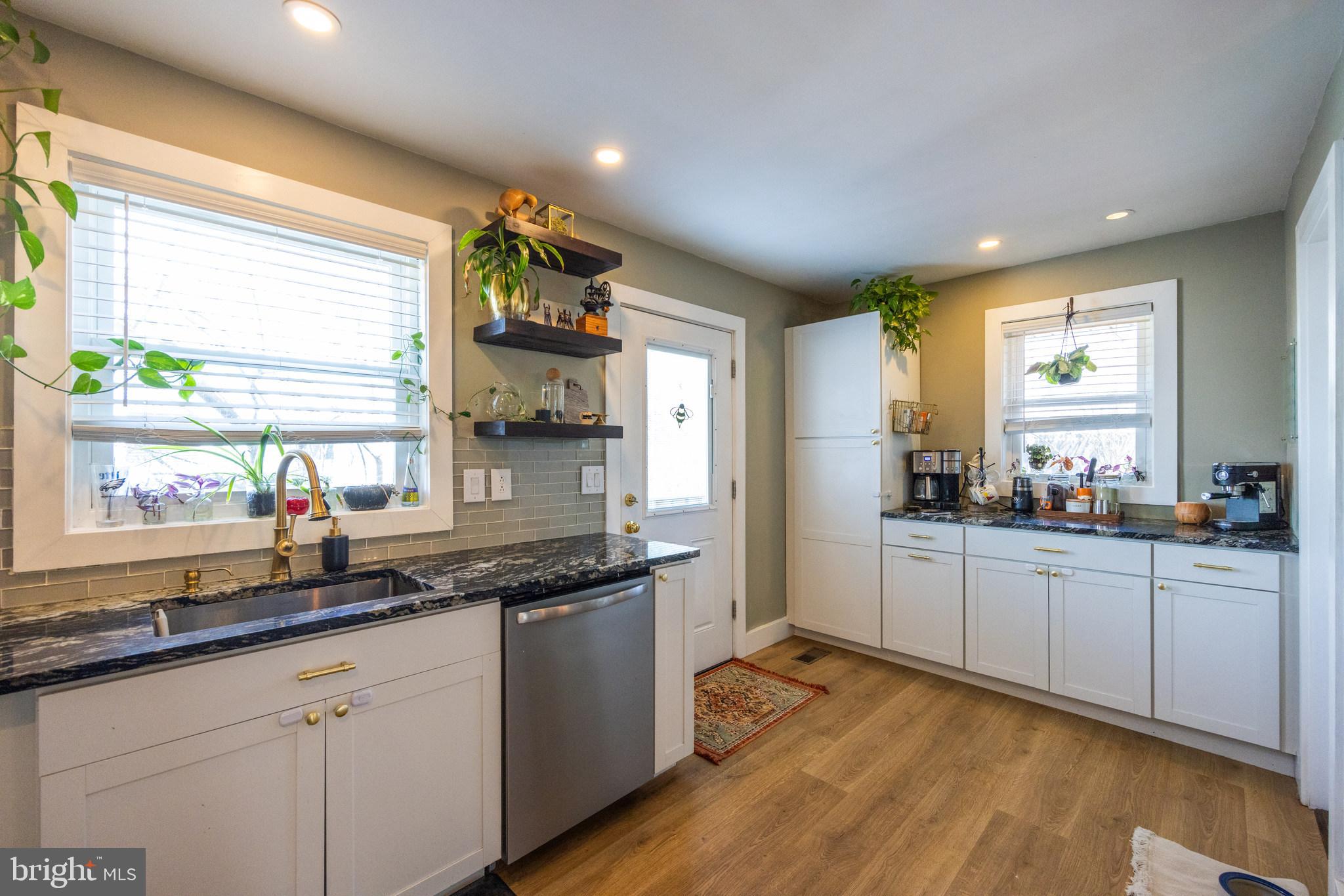 178 Devon Drive West Deptford, NJ 08096 - Photo 10 of 29 a kitchen with counter top space sink and wooden floor