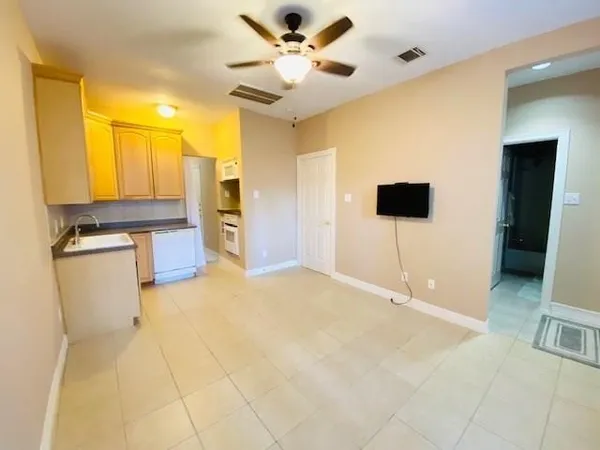 a view of an empty room with a kitchen