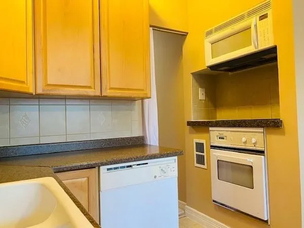 a kitchen with a sink and a stove top oven