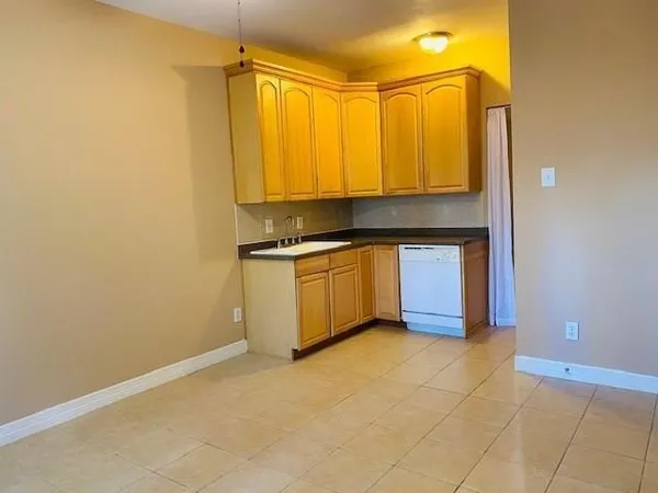 a kitchen with a sink cabinets and utility
