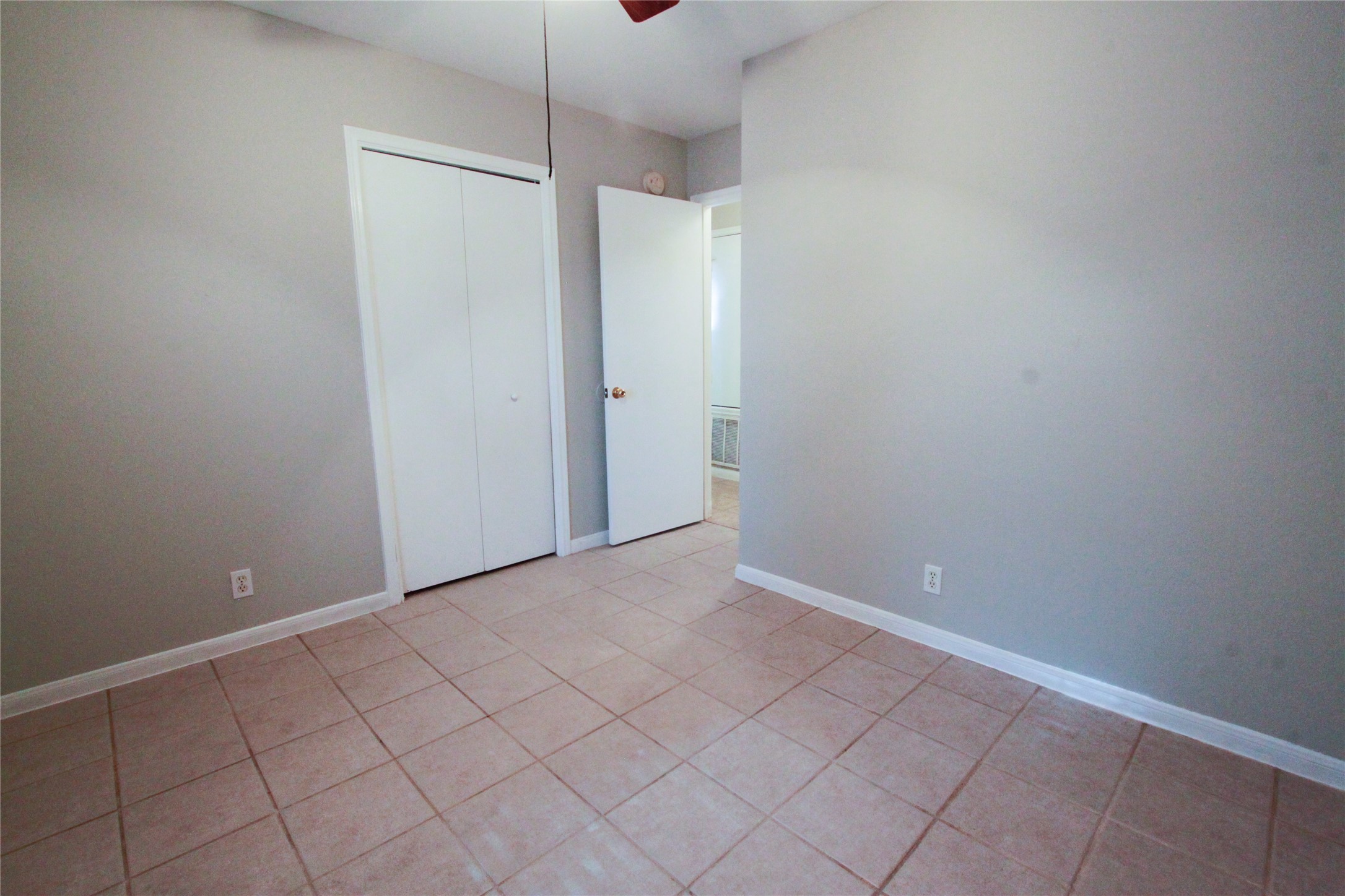 14708 Highsmith Street Austin, TX 78725 - Photo 21 of 28 Unfurnished bedroom with a closet, light tile patterned flooring, and ceiling fan