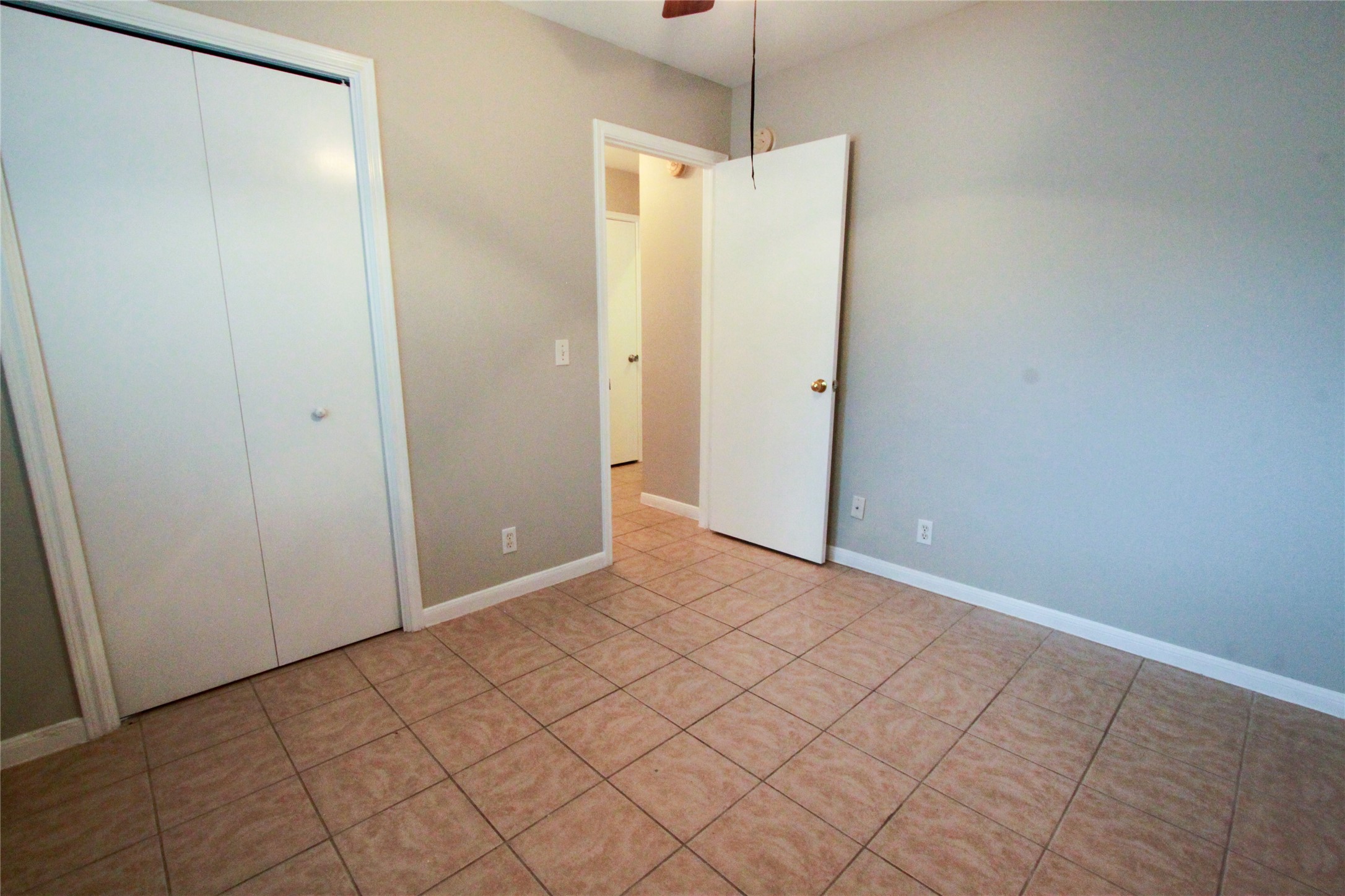 14708 Highsmith Street Austin, TX 78725 - Photo 23 of 28 Unfurnished bedroom featuring a closet, ceiling fan, and light tile patterned floors
