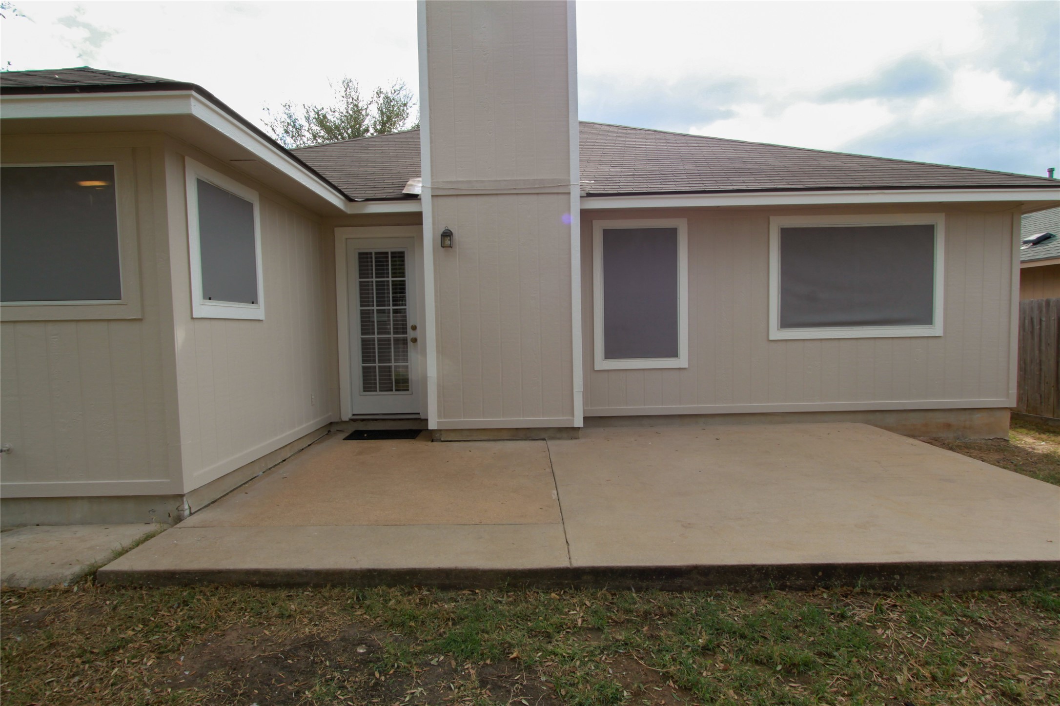 14708 Highsmith Street Austin, TX 78725 - Photo 26 of 28 Back of property with roof with shingles and a patio