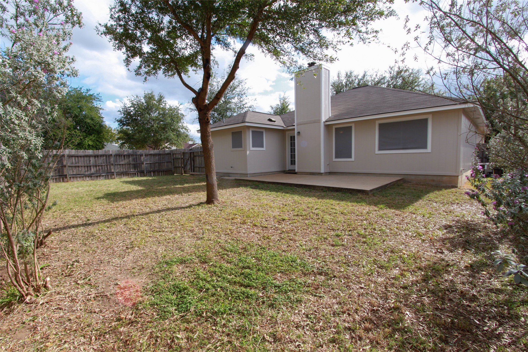 14708 Highsmith Street Austin, TX 78725 - Photo 27 of 28 Rear view of property with a patio, a chimney, and a fenced backyard