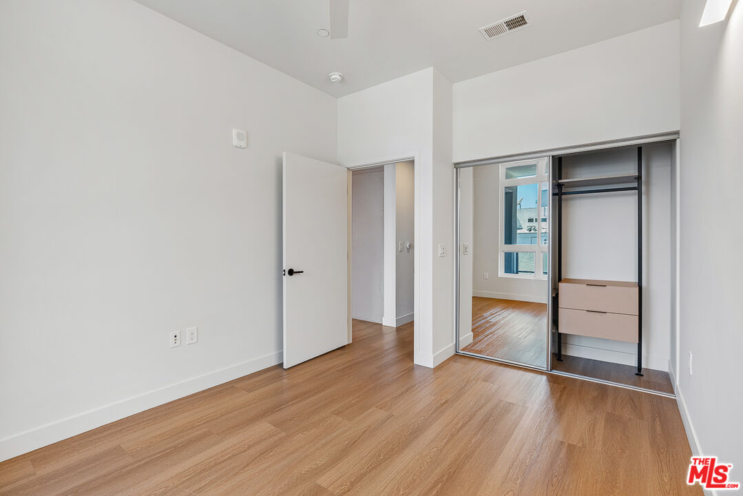 10601 Washington Boulevard, Unit 217 Culver City, CA 90232 - Photo 11 of 29 an empty room with wooden floor & mirror