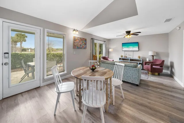 a view of a dining room with furniture and a wooden floor