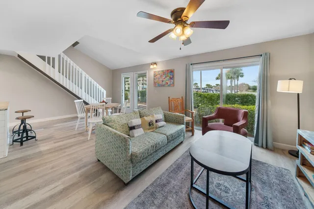 a living room with furniture a rug and a large window
