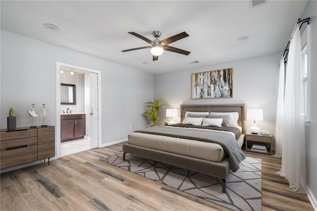 2914 Lenox Road Northeast, Unit 3 Atlanta, GA 30324 - Photo 1 of 1 a bedroom with a bed and a chandelier