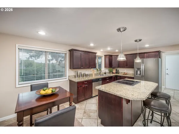a kitchen with a refrigerator and a wooden cabinets