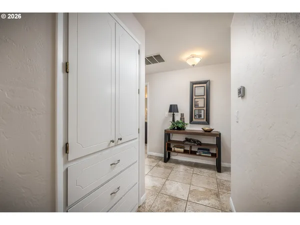 a bathroom with a tub and a view of living room