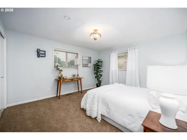 a bedroom with a bed and a table