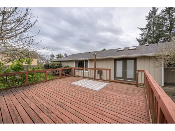 a front view of house with yard outdoor seating and barbeque in the background