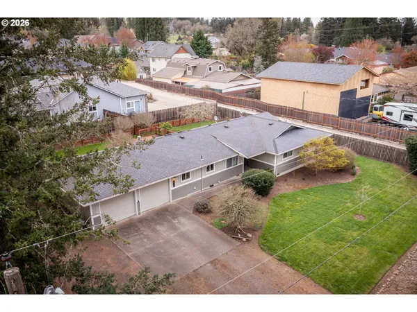 an aerial view of a house with yard swimming pool and mountains