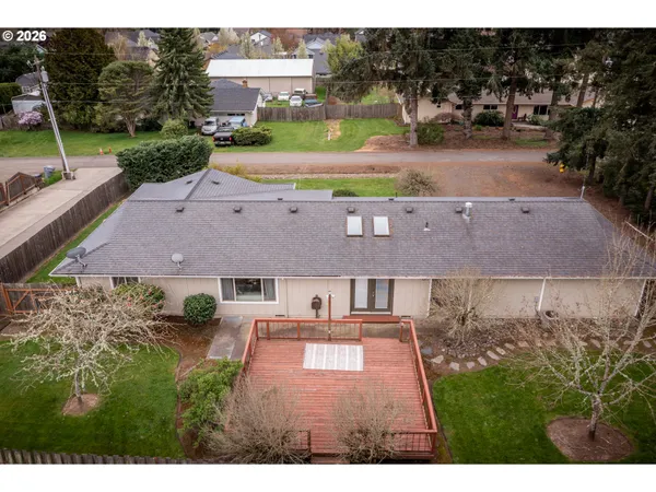 an aerial view of a house with a yard