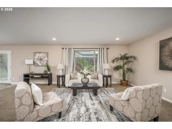 a living room with furniture and a large window