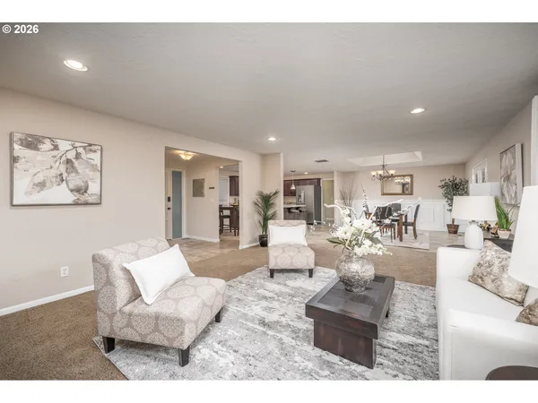 a living room with furniture and a large mirror