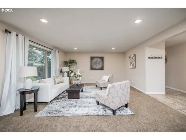 a living room with furniture and a large window