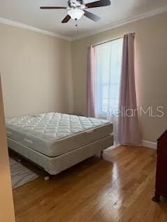 a bedroom with a bed and window