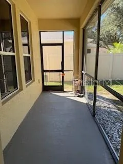 a view of an empty room with large windows