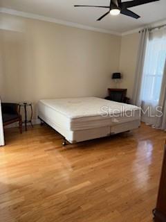 1027 Orca Court Holiday, FL 34691 - Photo 7 of 14 a bedroom with a bed and a table in it