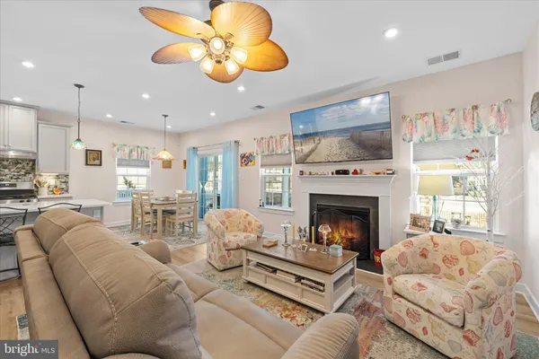 a living room with furniture fireplace and window
