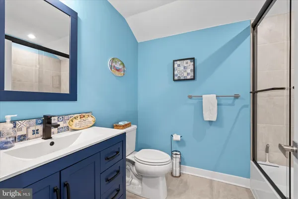 a bathroom with a sink mirror vanity and toilet