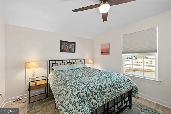 a bed sitting in a bedroom next to a window