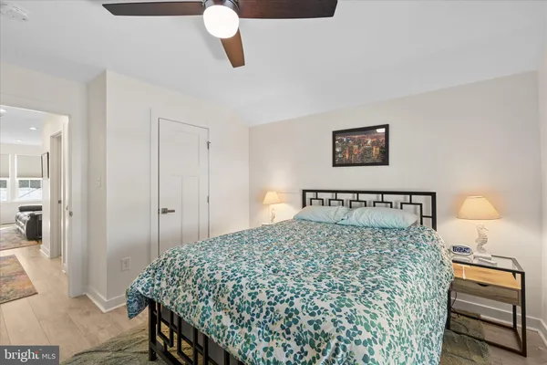a bedroom with a bed and a lamp on table