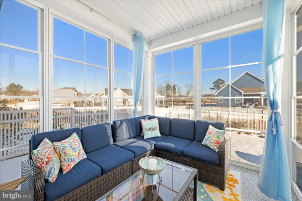 a living room with furniture a city view and a large window