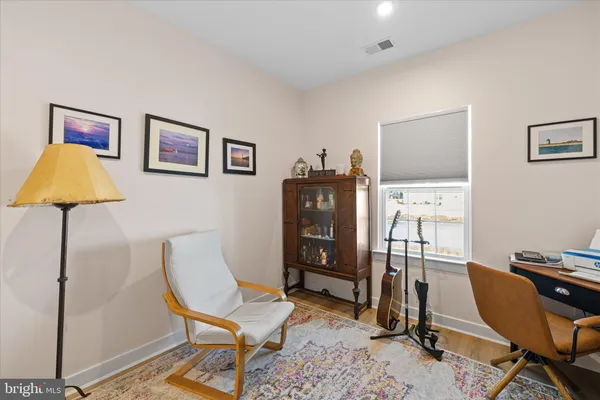 a view of a workspace with furniture and lounge chair