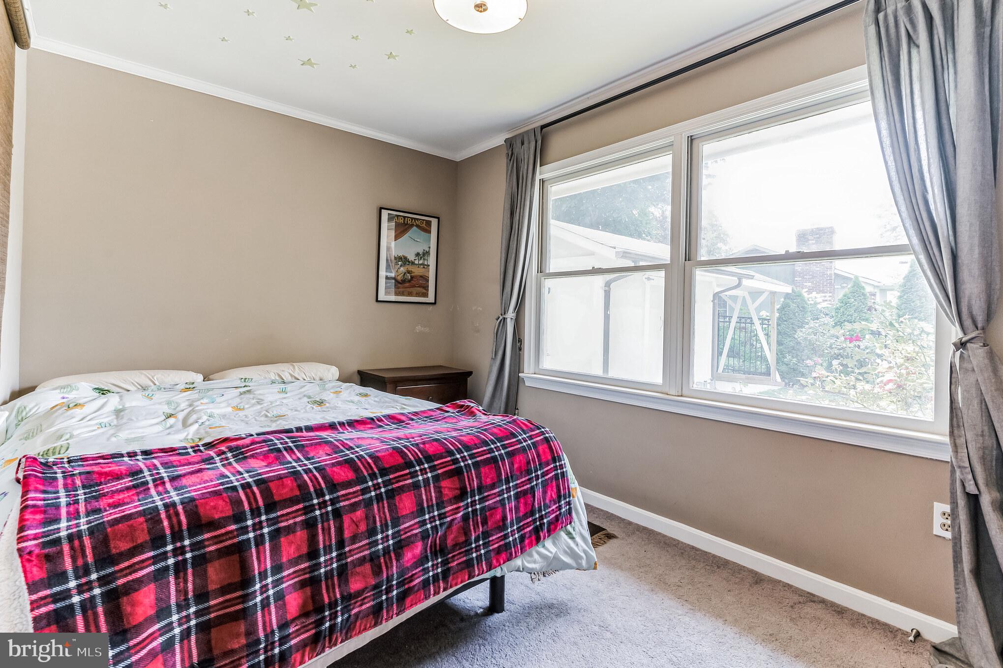 9329 Harvey Road Silver Spring, MD 20910 - Photo 23 of 40 a bedroom with a bed and a window