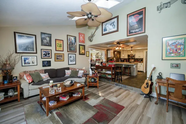 a view of a livingroom with furniture a flat screen tv and a fireplace