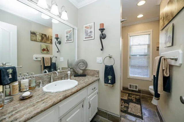 a kitchen with sink cabinets and stove top oven