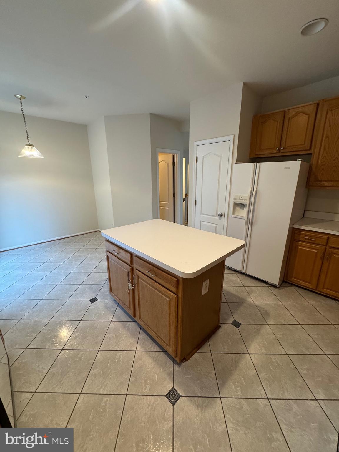 7705 Periwinkle Way, Unit 71 Severn, MD 21144 - Photo 15 of 28 a kitchen with a cabinets and wooden floor