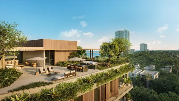an aerial view of a house with outdoor seating