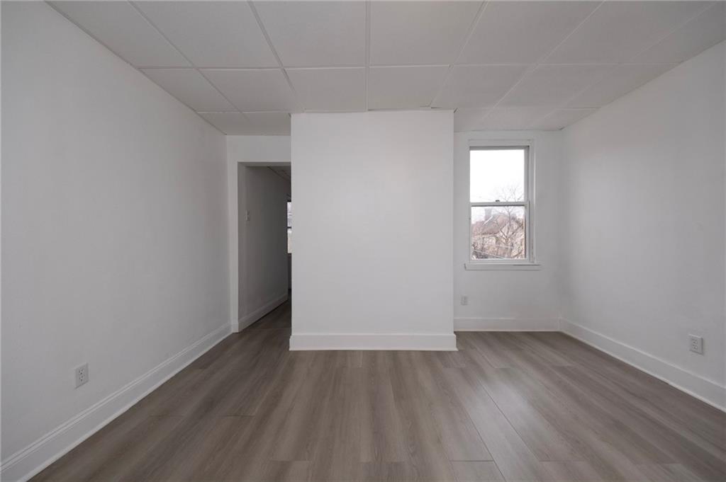 108 Margaret Street McKees Rocks, PA 15136 - Photo 13 of 29 an empty room with wooden floor and windows